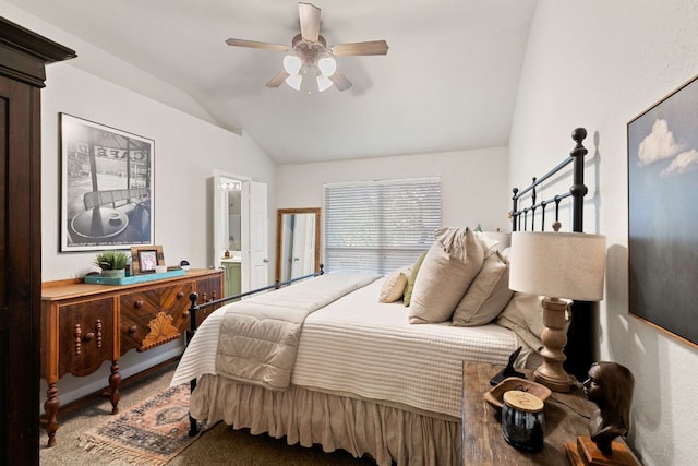 bedroom with carpet floors, a ceiling fan, connected bathroom, and vaulted ceiling