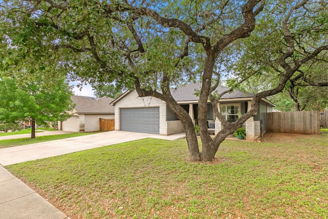 view of front of home featuring fence, a front yard, driveway, and a garage