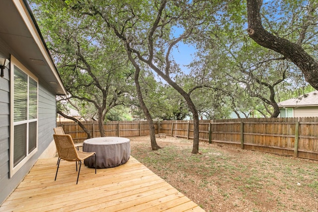 wooden terrace featuring a fenced backyard and a hot tub