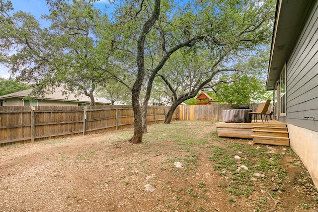 view of yard featuring a fenced backyard and a wooden deck