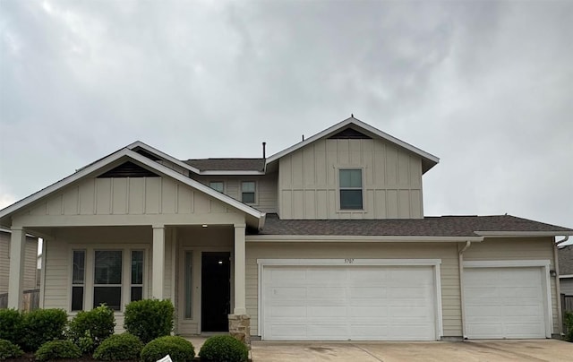 view of front facade with an attached garage, board and batten siding, roof with shingles, and driveway