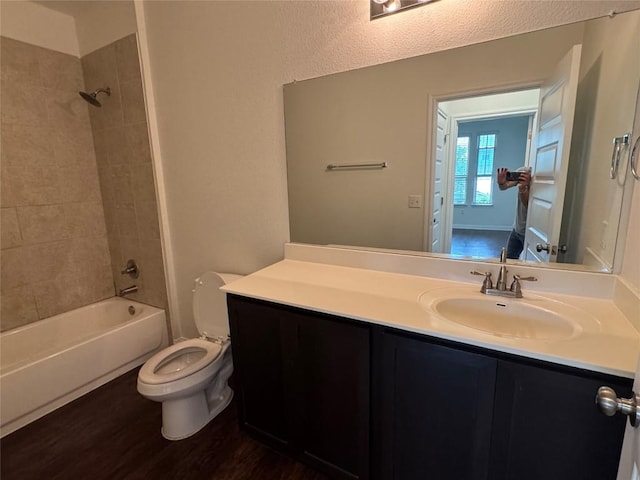 full bathroom with vanity, tub / shower combination, toilet, and wood finished floors