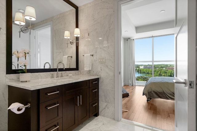 bathroom with vanity and tile walls