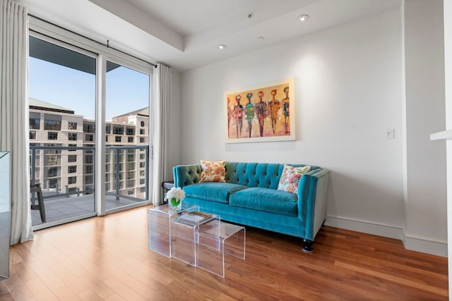living area with baseboards, recessed lighting, and wood finished floors
