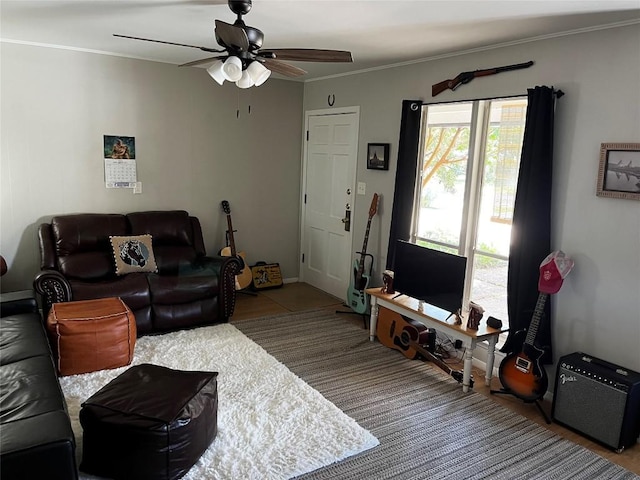 living room with ceiling fan and ornamental molding