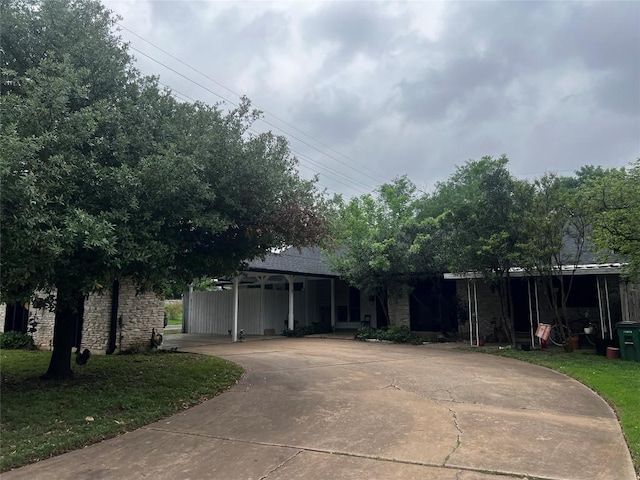 view of front of property featuring driveway and stone siding