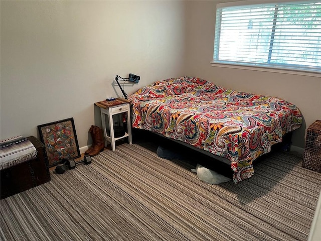 carpeted bedroom featuring baseboards