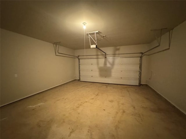 garage with baseboards and a garage door opener