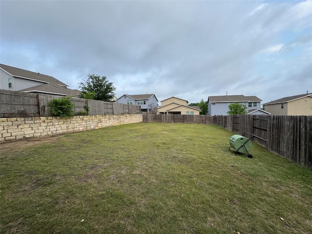view of yard with a fenced backyard