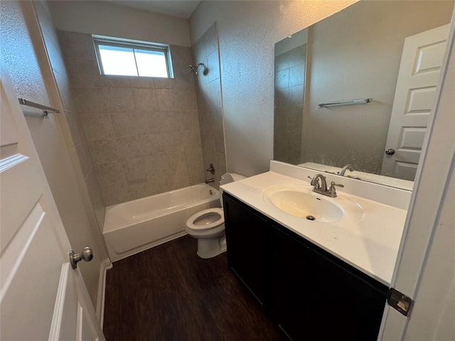 bathroom featuring bathing tub / shower combination, vanity, toilet, and wood finished floors