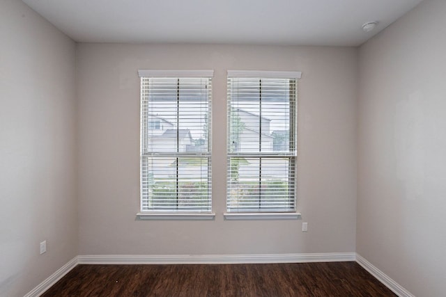 5816 Monmarte Cv, Austin, TX 78744 - empty room with plenty of natural light, baseboards, and dark wood finished floors