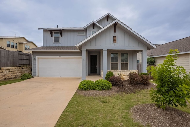 5816 Monmarte Cv, Austin, TX 78744 - view of front of home with board and batten siding, an attached garage, driveway, covered porch, and a shingled roof
