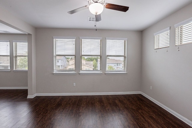 5816 Monmarte Cv, Austin, TX 78744 - unfurnished room featuring dark wood-type flooring, baseboards, and a ceiling fan