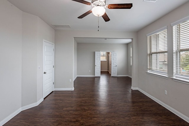 5816 Monmarte Cv, Austin, TX 78744 - unfurnished room with dark wood-style floors, a ceiling fan, and baseboards