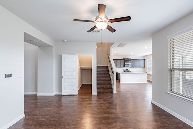 5816 Monmarte Cv, Austin, TX 78744 - unfurnished living room featuring ceiling fan, dark wood finished floors, and stairway