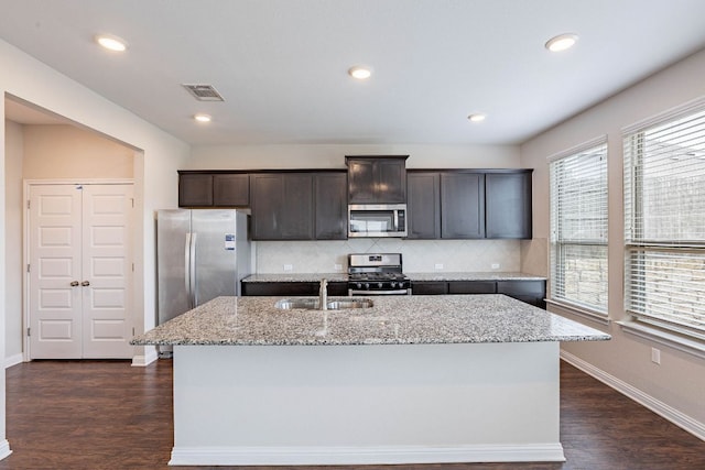 5816 Monmarte Cv, Austin, TX 78744 - kitchen with appliances with stainless steel finishes, a sink, backsplash, baseboards, and dark wood-style floors