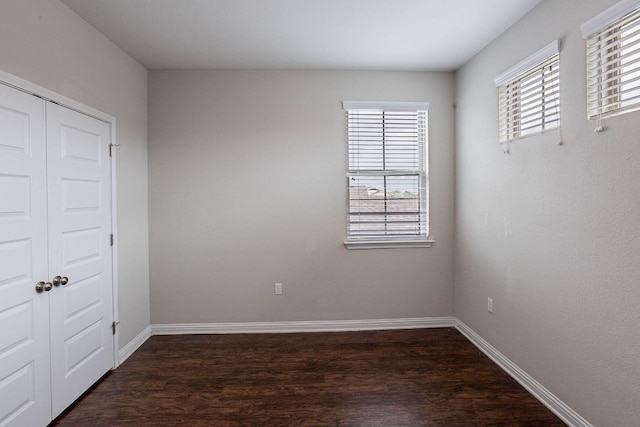 5816 Monmarte Cv, Austin, TX 78744 - spare room featuring dark wood-style flooring and baseboards