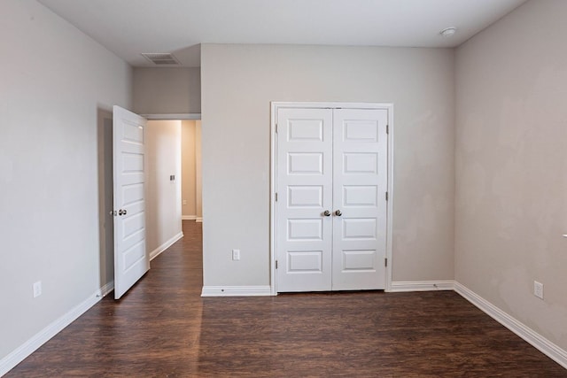 5816 Monmarte Cv, Austin, TX 78744 - unfurnished bedroom featuring dark wood-type flooring, baseboards, and a closet