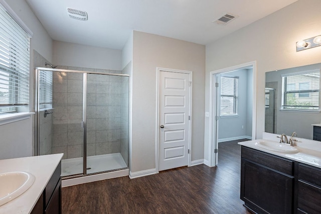 5816 Monmarte Cv, Austin, TX 78744 - full bath featuring two vanities, a stall shower, and wood finished floors