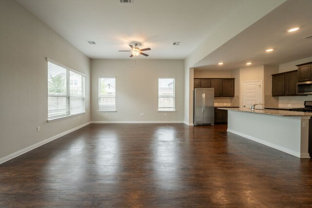 5817 Gerard Dr, Austin, TX 78744 - unfurnished living room featuring ceiling fan, dark wood-style flooring, recessed lighting, a sink, and baseboards