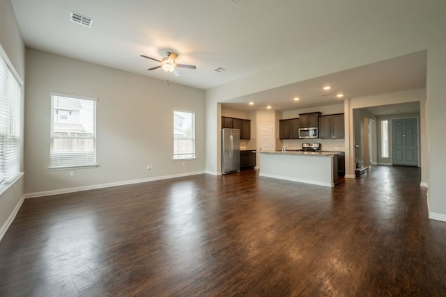 5817 Gerard Dr, Austin, TX 78744 - unfurnished living room with plenty of natural light, ceiling fan, baseboards, and recessed lighting