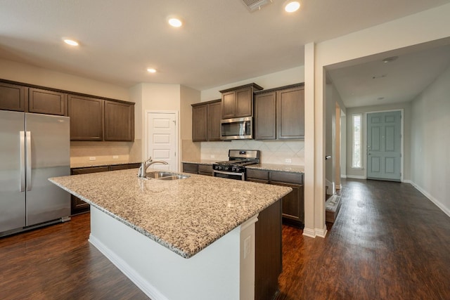 5817 Gerard Dr, Austin, TX 78744 - kitchen with stainless steel appliances, a sink, dark wood-type flooring, dark brown cabinetry, and recessed lighting
