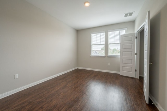 5817 Gerard Dr, Austin, TX 78744 - unfurnished bedroom featuring dark wood-style floors and baseboards