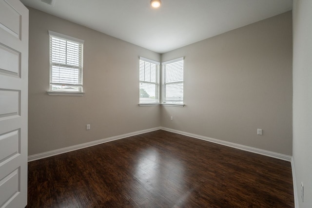 5817 Gerard Dr, Austin, TX 78744 - unfurnished room featuring plenty of natural light, dark wood-style floors, and baseboards