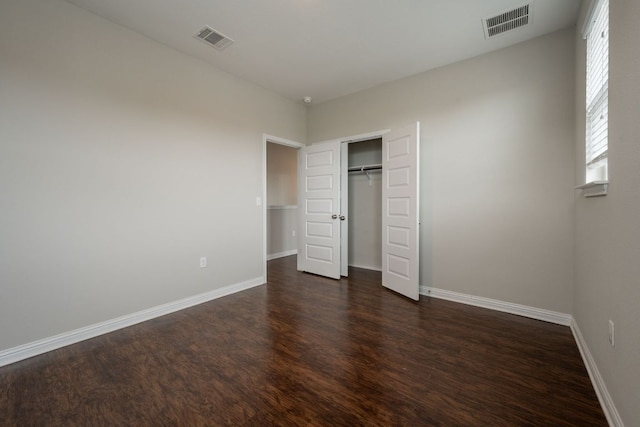 5817 Gerard Dr, Austin, TX 78744 - unfurnished bedroom with dark wood-type flooring, baseboards, and a closet