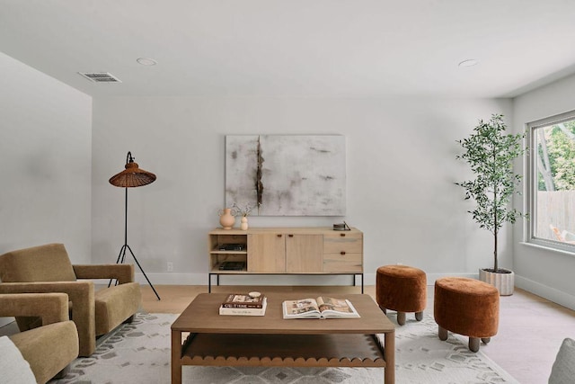 living area with visible vents, recessed lighting, and baseboards