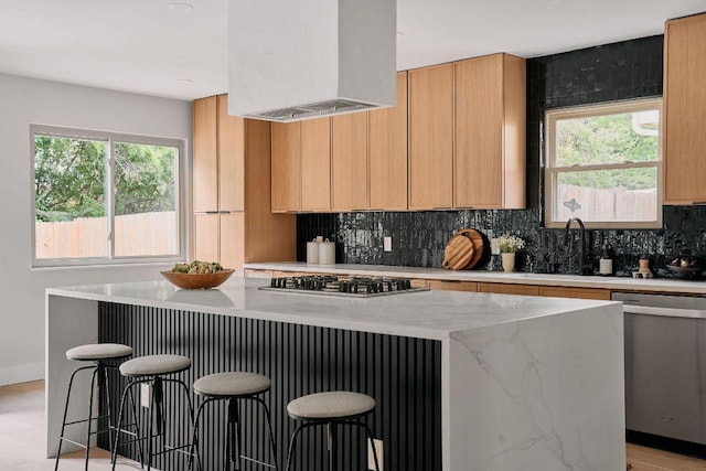 kitchen featuring appliances with stainless steel finishes, tasteful backsplash, a kitchen bar, a kitchen island, and custom exhaust hood