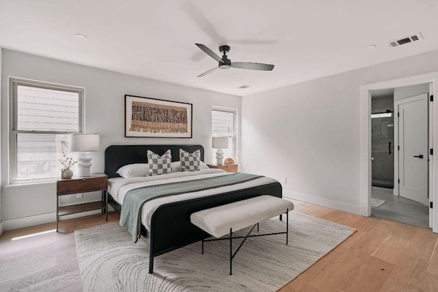 bedroom featuring light wood-style floors, baseboards, a ceiling fan, and visible vents