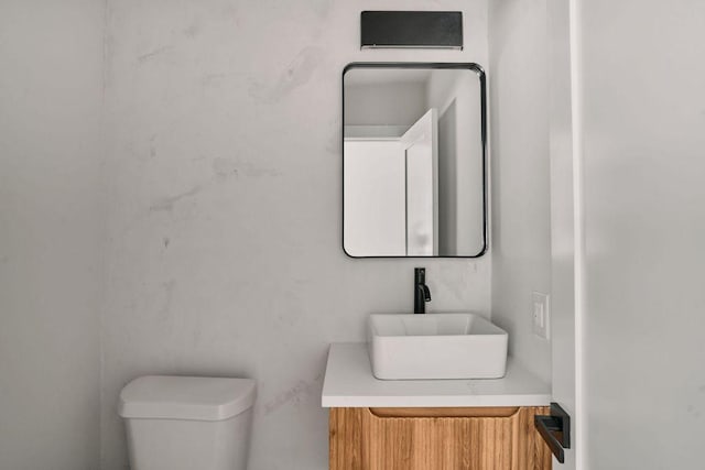half bath featuring toilet and vanity