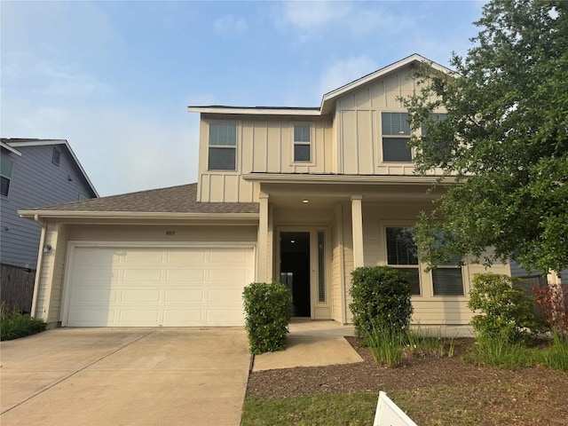 view of front of home with board and batten siding, concrete driveway, a porch, and a garage