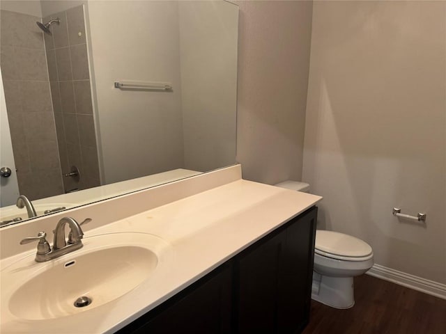 bathroom with vanity, walk in shower, and toilet