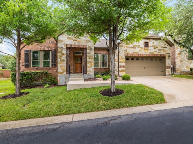 view of front facade with a front yard, driveway, an attached garage, and stone siding