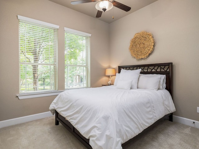 bedroom featuring baseboards, ceiling fan, and carpet floors