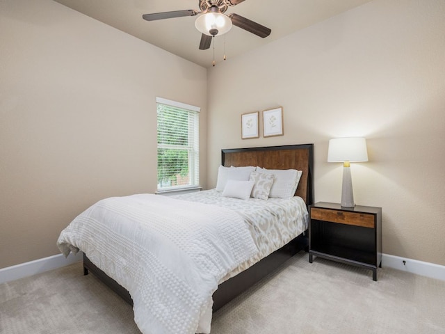 carpeted bedroom with a ceiling fan and baseboards