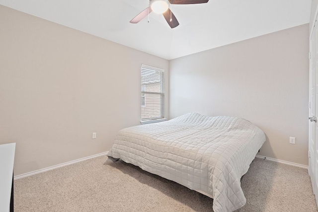 carpeted bedroom with baseboards and ceiling fan