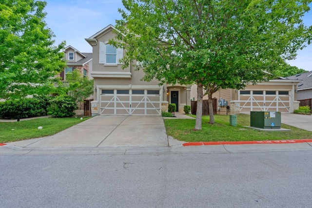 view of front of home with a garage, driveway, a front yard, and stucco siding