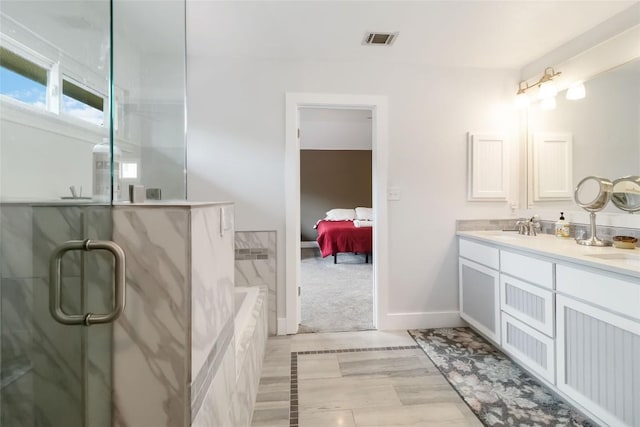 1400 Hargis Creek Trl, Austin, TX 78717 - ensuite bathroom with double vanity, a tub to relax in, an enclosed shower, and baseboards