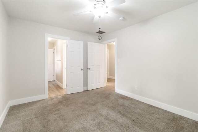 1400 Hargis Creek Trl, Austin, TX 78717 - unfurnished bedroom with carpet flooring, baseboards, and a ceiling fan