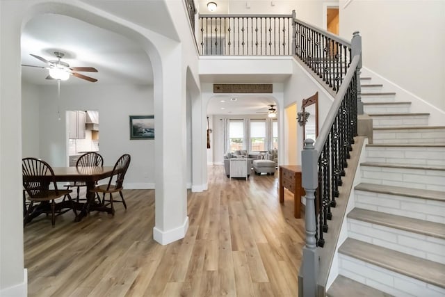 1400 Hargis Creek Trl, Austin, TX 78717 - foyer with ceiling fan, arched walkways, wood finished floors, and stairway