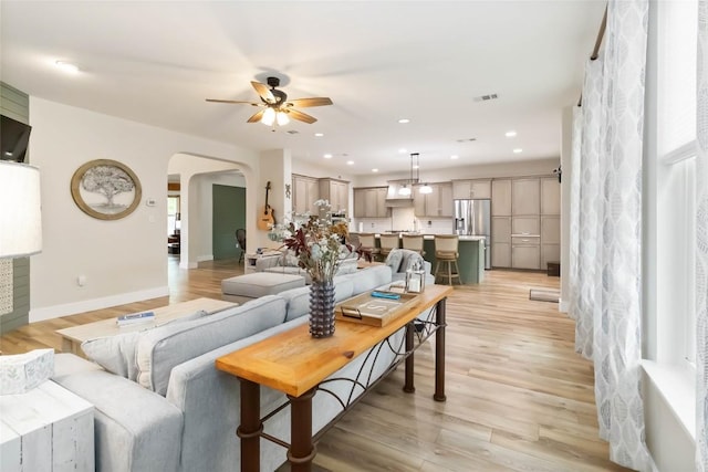 1400 Hargis Creek Trl, Austin, TX 78717 - living room featuring arched walkways, a ceiling fan, light wood-type flooring, baseboards, and recessed lighting
