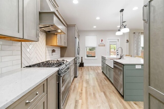 1400 Hargis Creek Trl, Austin, TX 78717 - kitchen featuring appliances with stainless steel finishes, a sink, custom exhaust hood, light wood-style flooring, and tasteful backsplash