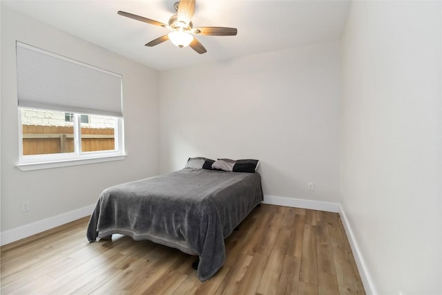 1400 Hargis Creek Trl, Austin, TX 78717 - bedroom with wood finished floors, baseboards, and a ceiling fan