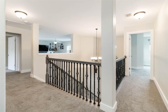 1400 Hargis Creek Trl, Austin, TX 78717 - corridor featuring carpet floors, an upstairs landing, a chandelier, and baseboards