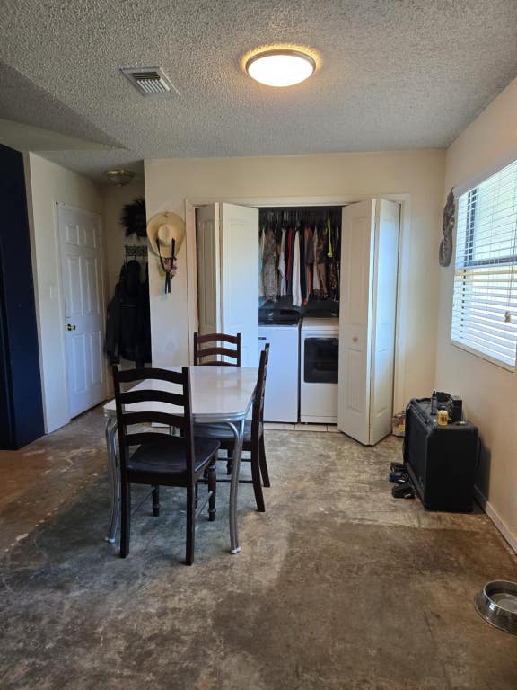 18215 Center St, Jonestown, TX 78645 - dining room featuring separate washer and dryer, a textured ceiling, and visible vents