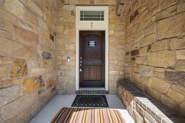 property entrance with stone siding