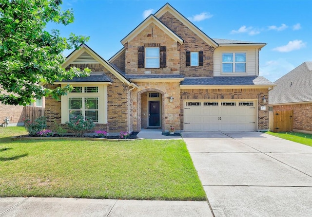 view of front of house featuring a front lawn, fence, brick siding, concrete driveway, and an attached garage